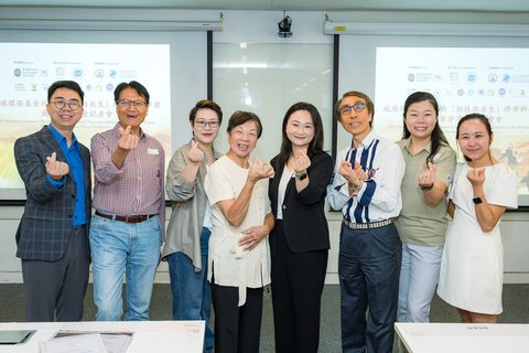 Guests pose together with finger hearts