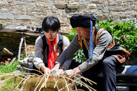 Learning bamboo weaving from a village elder